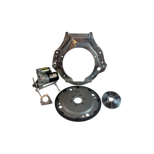 An automotive engine flywheel and clutch assembly kit with a metal flywheel, clutch disc, mounting bracket, and small motor component, displayed on a clean white background.