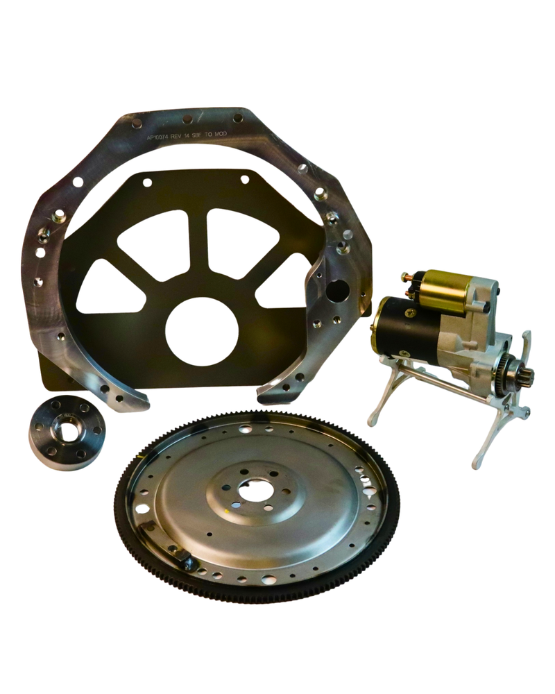 Mechanical components including a flywheel, clutch plate, and starter motor on a white background