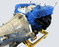 Automotive transmission with blue casing and yellow stand on a gray background