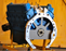 Engine block with blue and white components on a wooden background