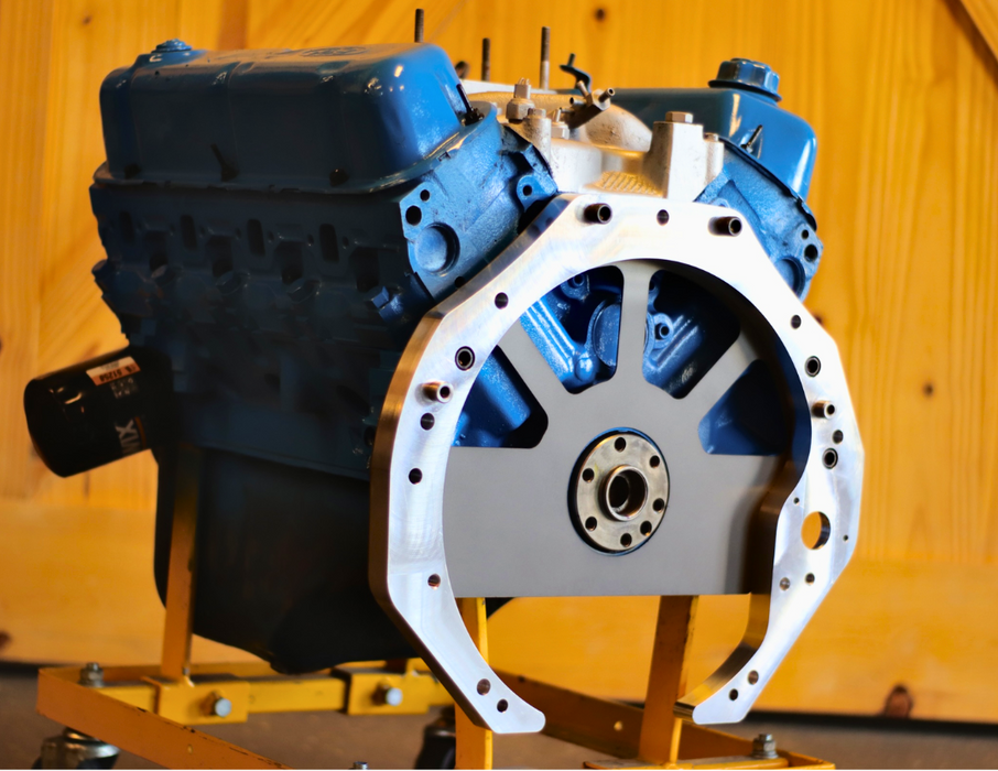 Engine block with blue and white components on a wooden background